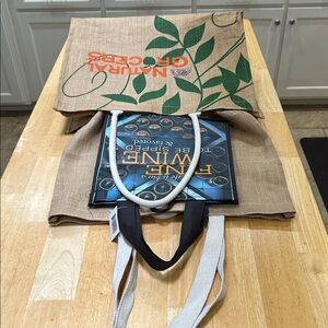 Two burlap large sturdy grocery bags and a Wine Tote Bag. All are new and clean.
